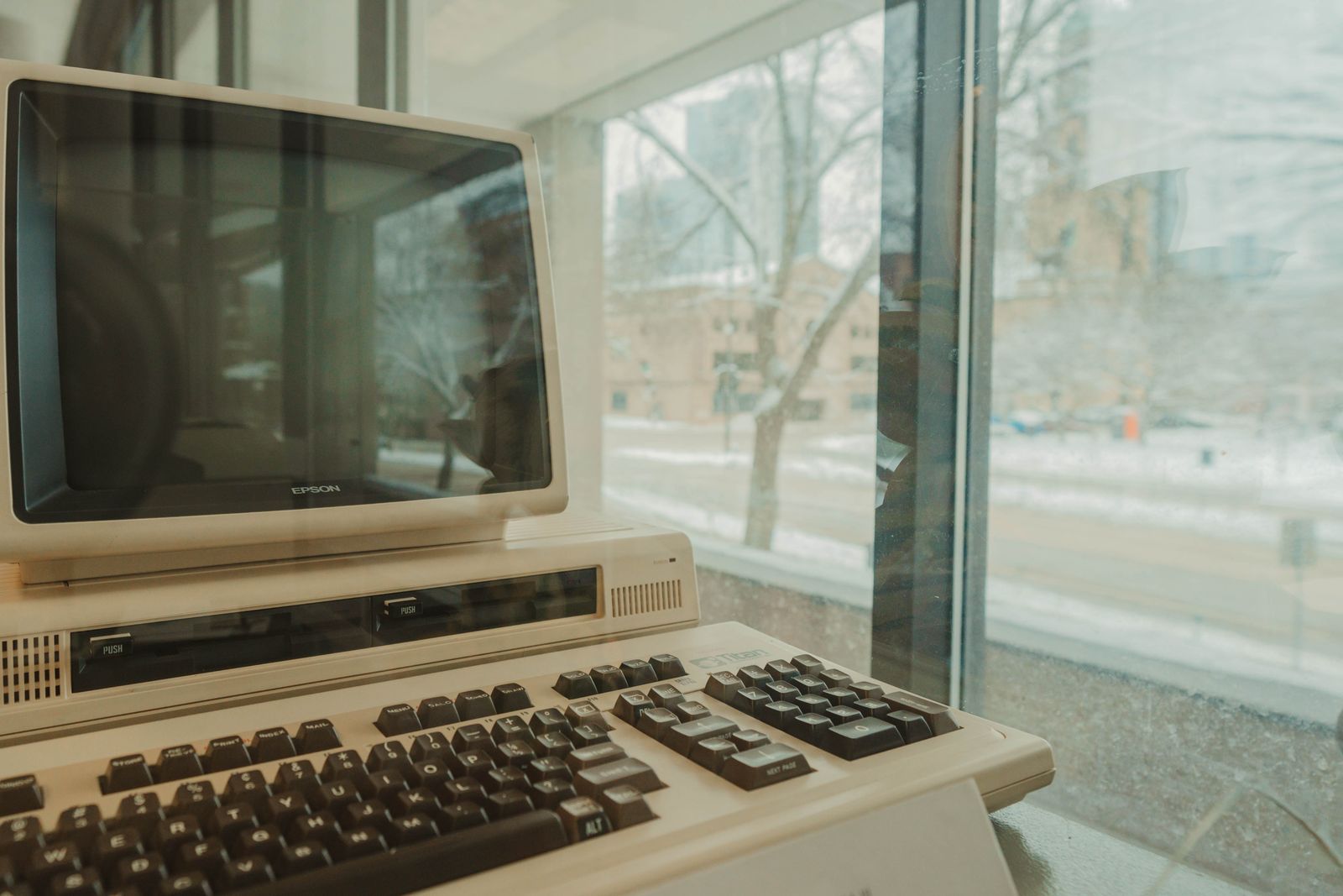 An old Epson computer by a snowy window — a symbol of the longevity and compatibility of legacy hardware