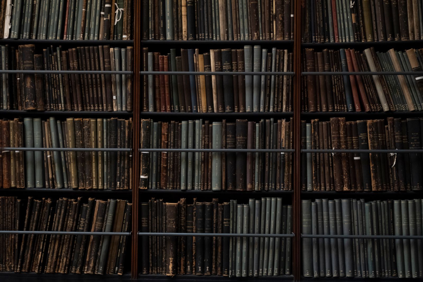 Dense rows of old bindings on archive shelves — a legacy largely digitized in DjVu