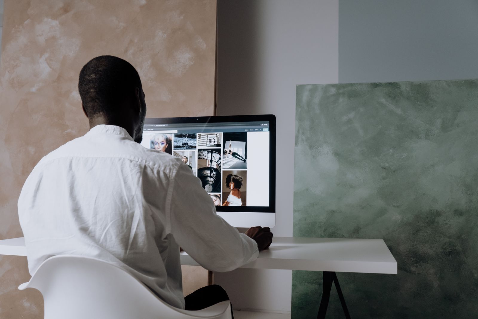 A person reviewing a photo library on a large screen before export
