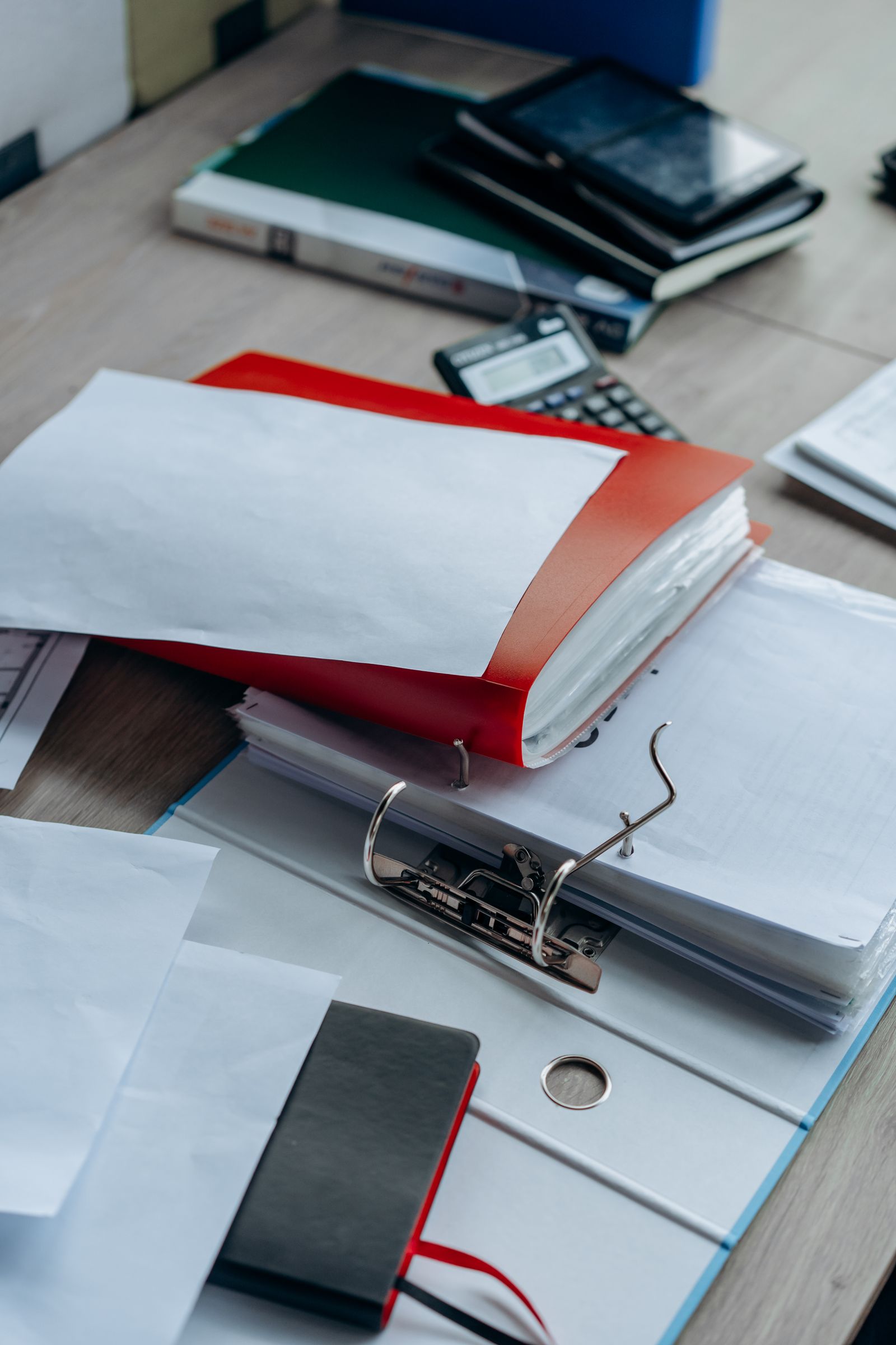 A person in a suit filling out a form in a folder — a typical document for scanning to PDF