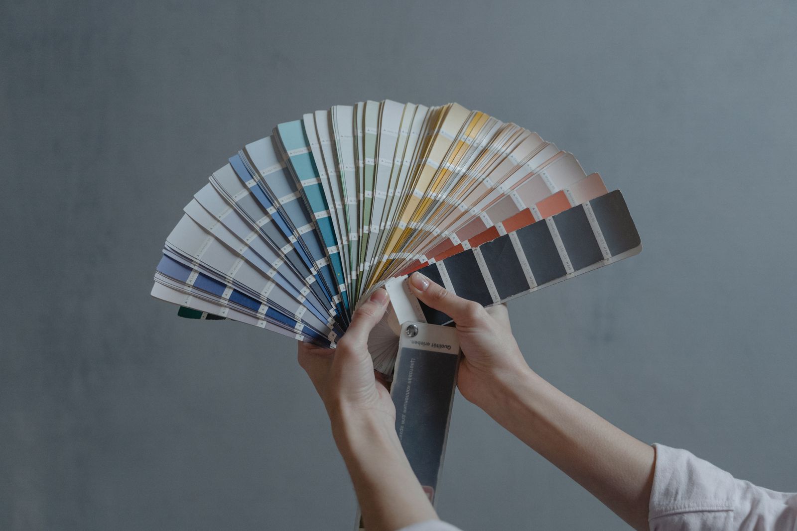 A fan of color swatches held in hand — PNG stores the exact color of each pixel plus its transparency