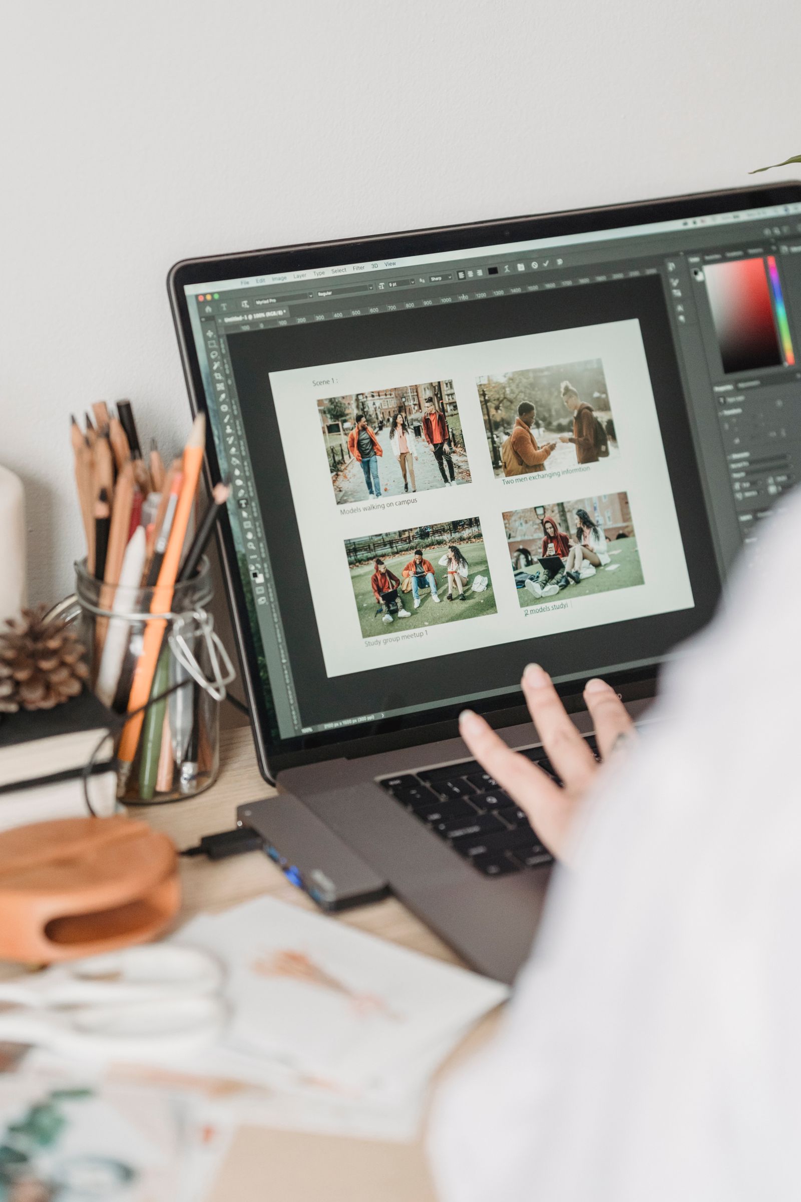 A laptop running Photoshop with a storyboard of several images laid out on the canvas