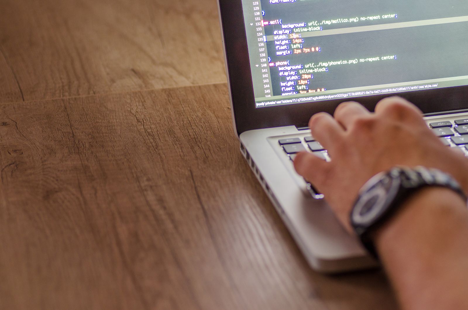 Hands at a laptop with code on the screen — opening and viewing a WebP file